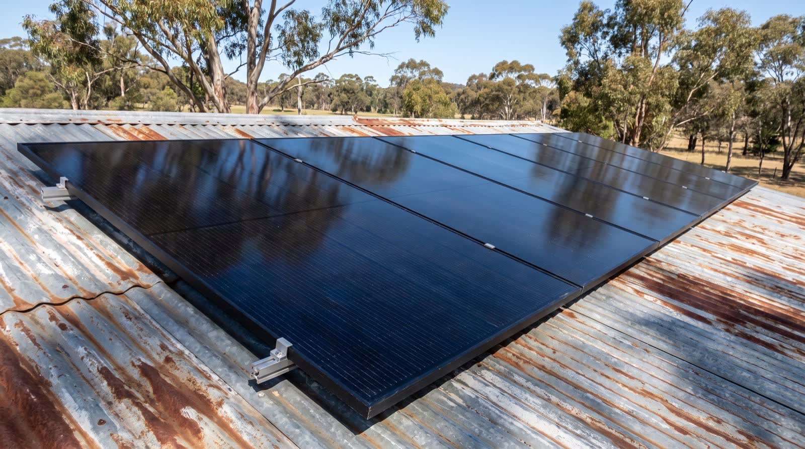 Close-up photo of solar panels mounted on the corrugated tin roof of an Australian country home